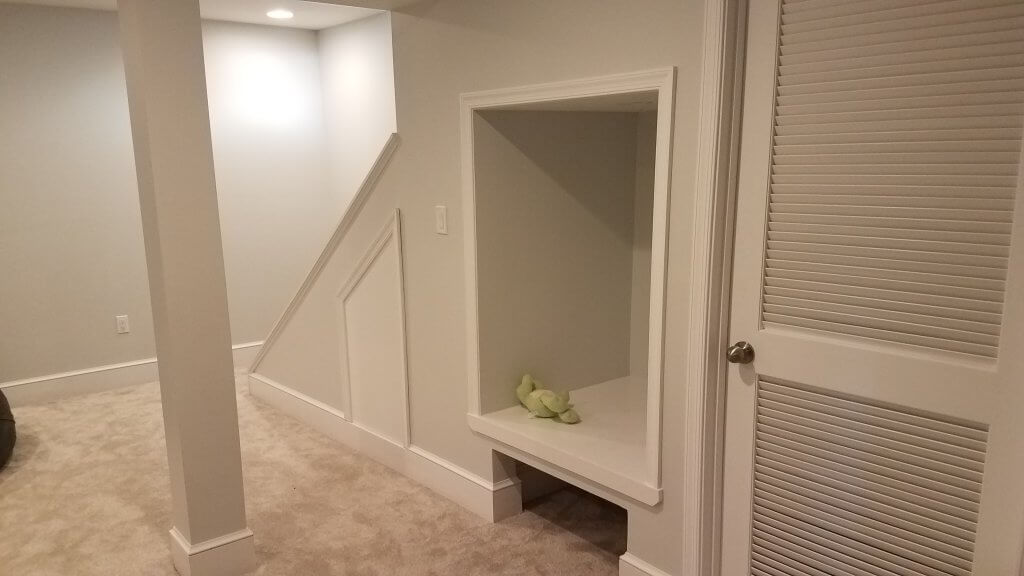 Basement remodeling allows knocks like this to be created under a staircase