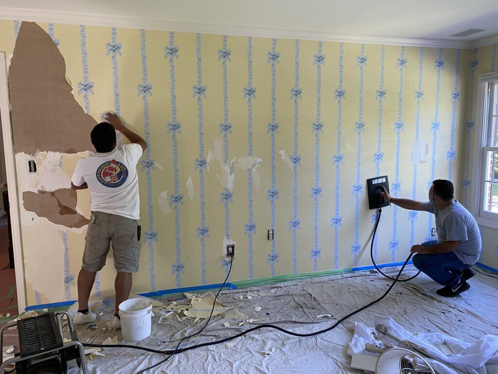 Klappenberger & Son Interior Painting Contractor removing wallpaper from bedroom