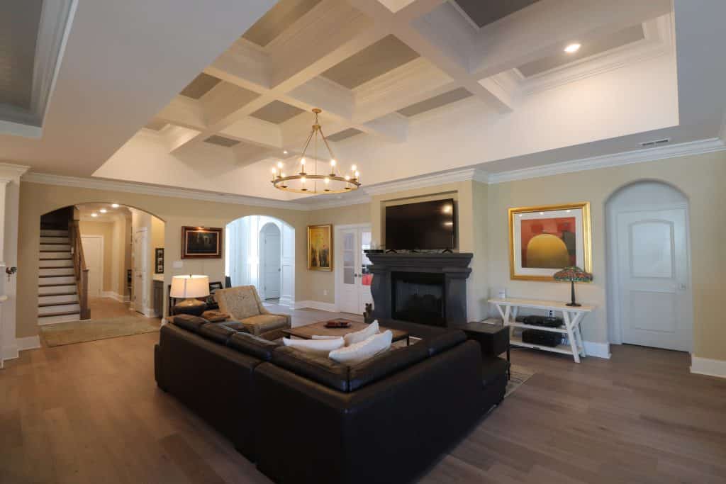 interior painting of living room with coffered ceiling