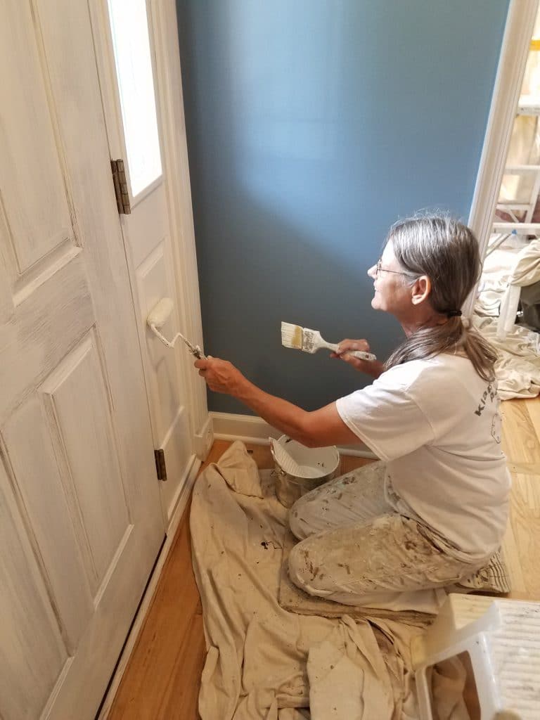 professional painter painting interior of front door