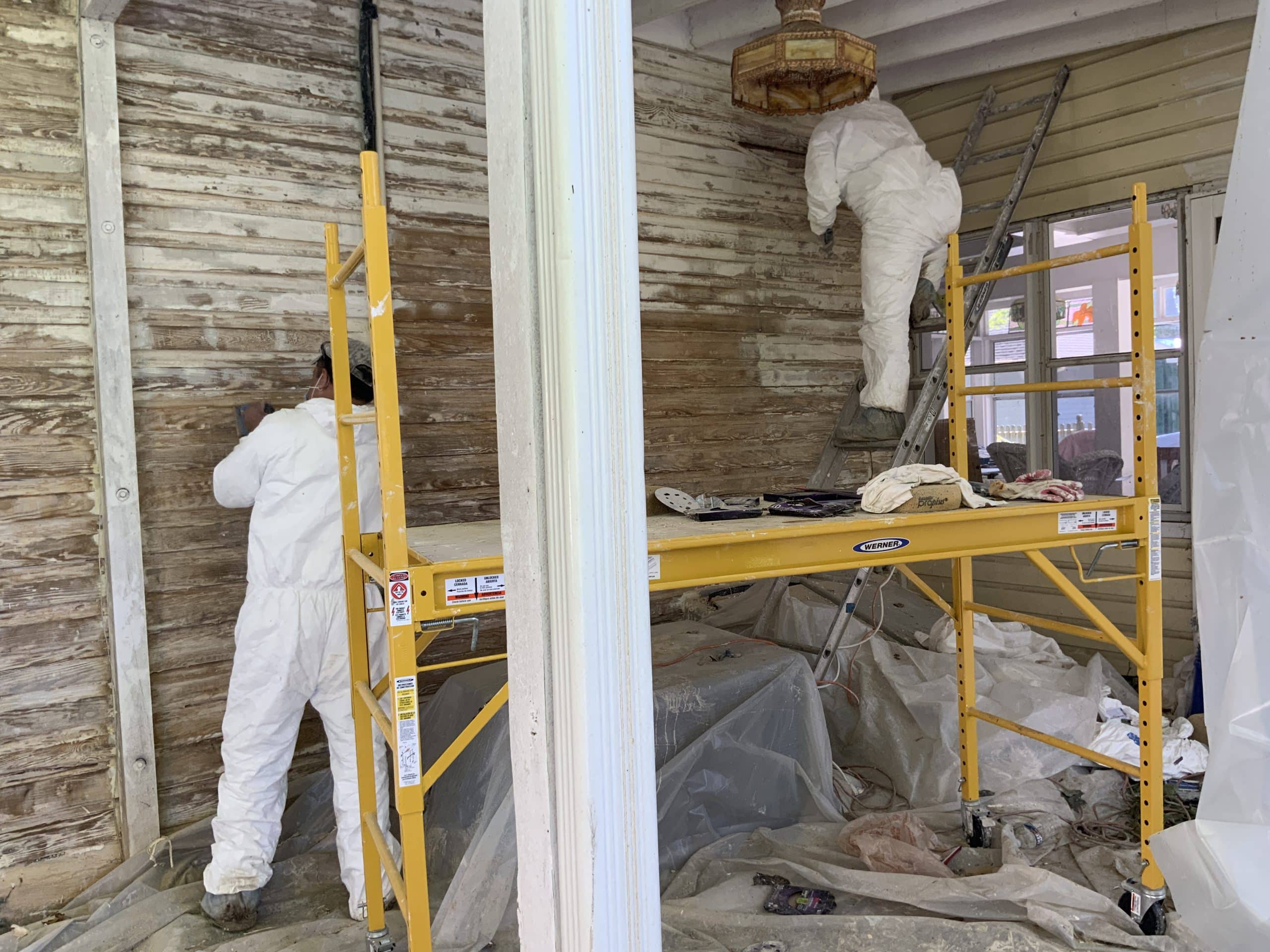 Historical restoration work , burning paint off siding