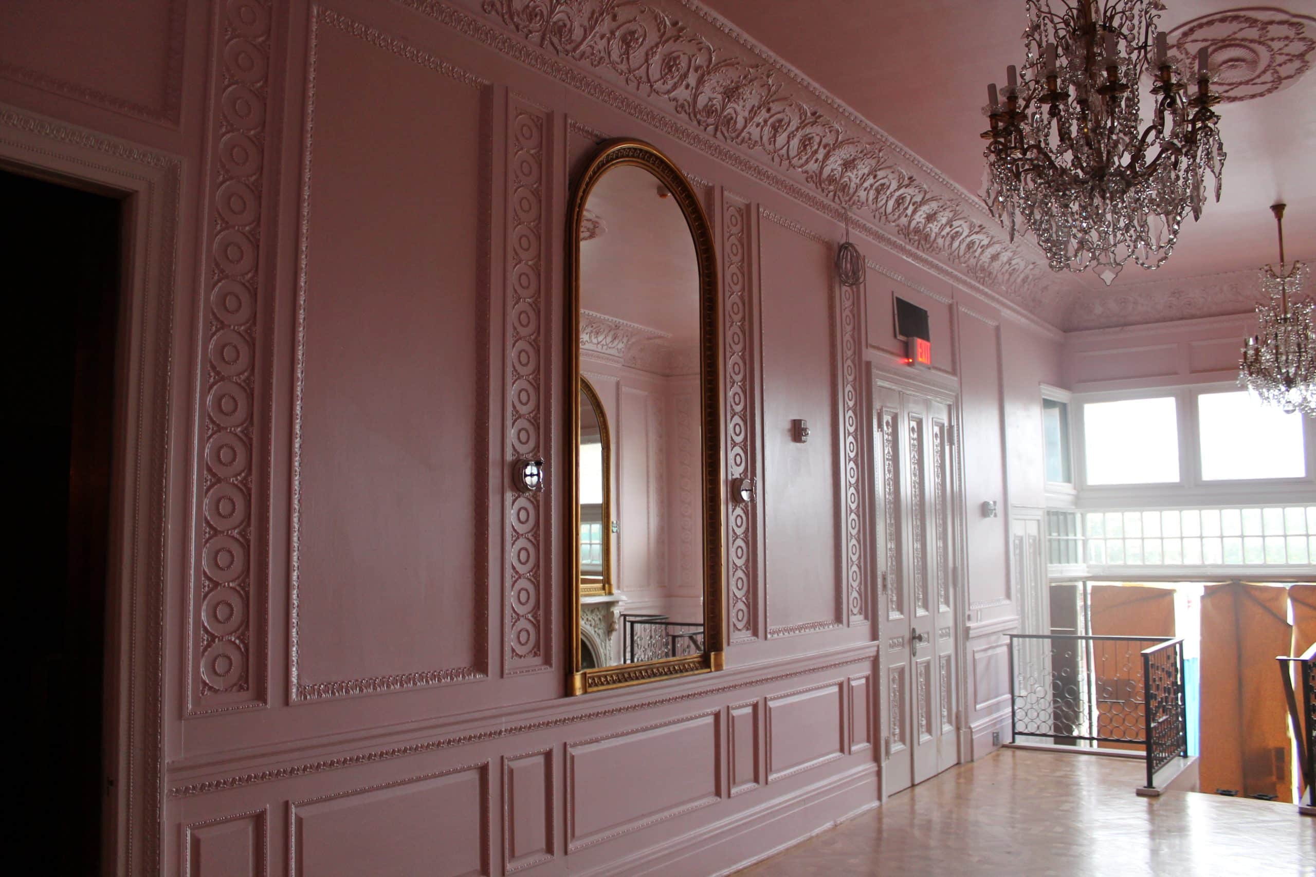 A Painting contractor in Nashville who painted these historic walls with lots of molding with a metallic pink paint.