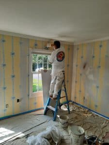 Spackle and paint over wallpaper