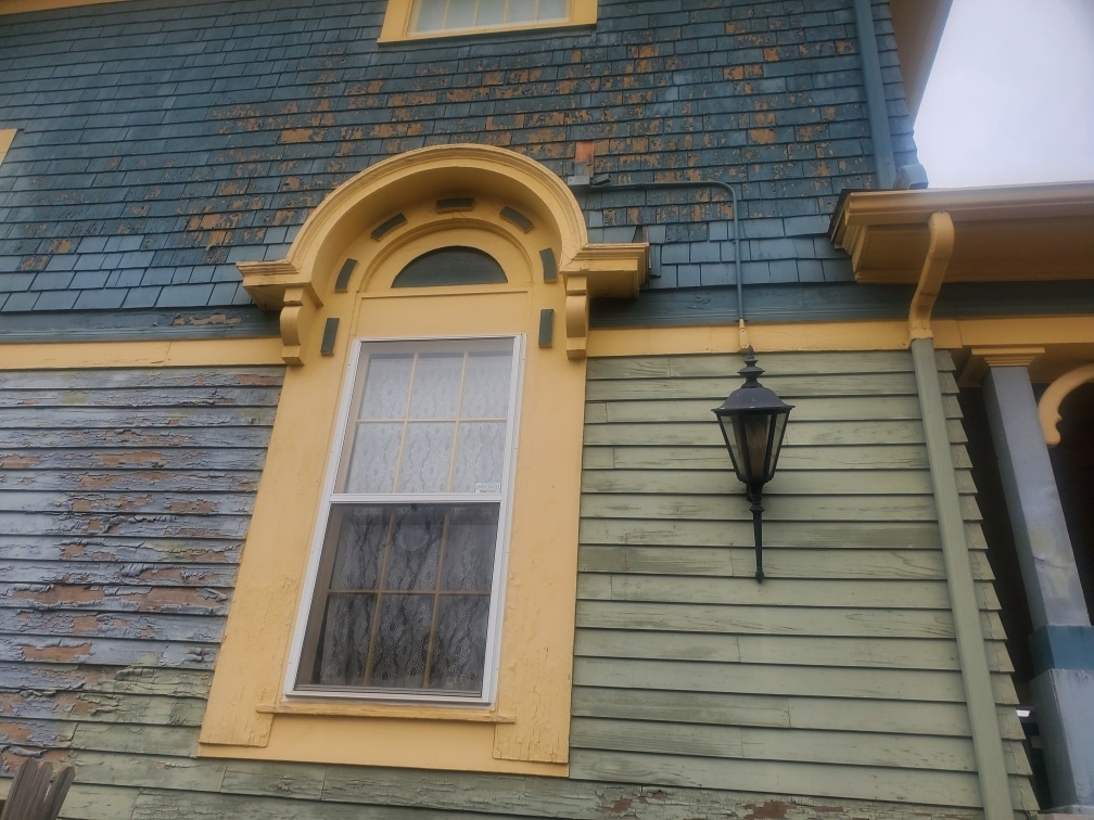Exterior painting in Edmond. This historic home has a lot of peeling paint.