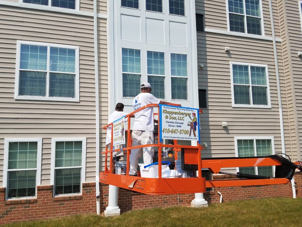 Commercial Painters In Atlanta on lift working painting building