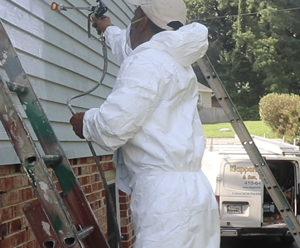 Oklahoma City painting company spraying painting exterior siding, Klappenberger & Son