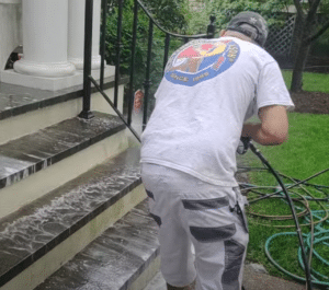 painters in montgomery county power washing front steps of house