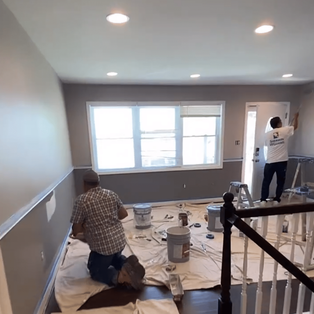 A painting contractor in Nashville painting the inside of a home two different colors.