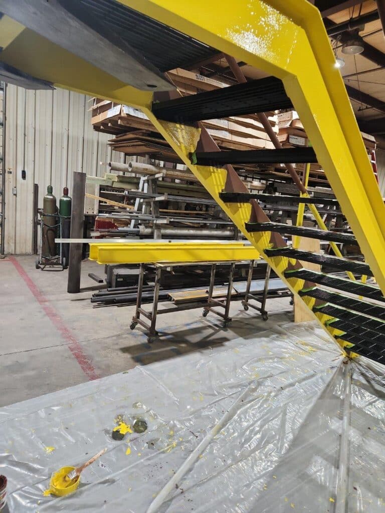 Government painting contractor Klappenberger & Son paints these black and yellow staircases at Airforce Base