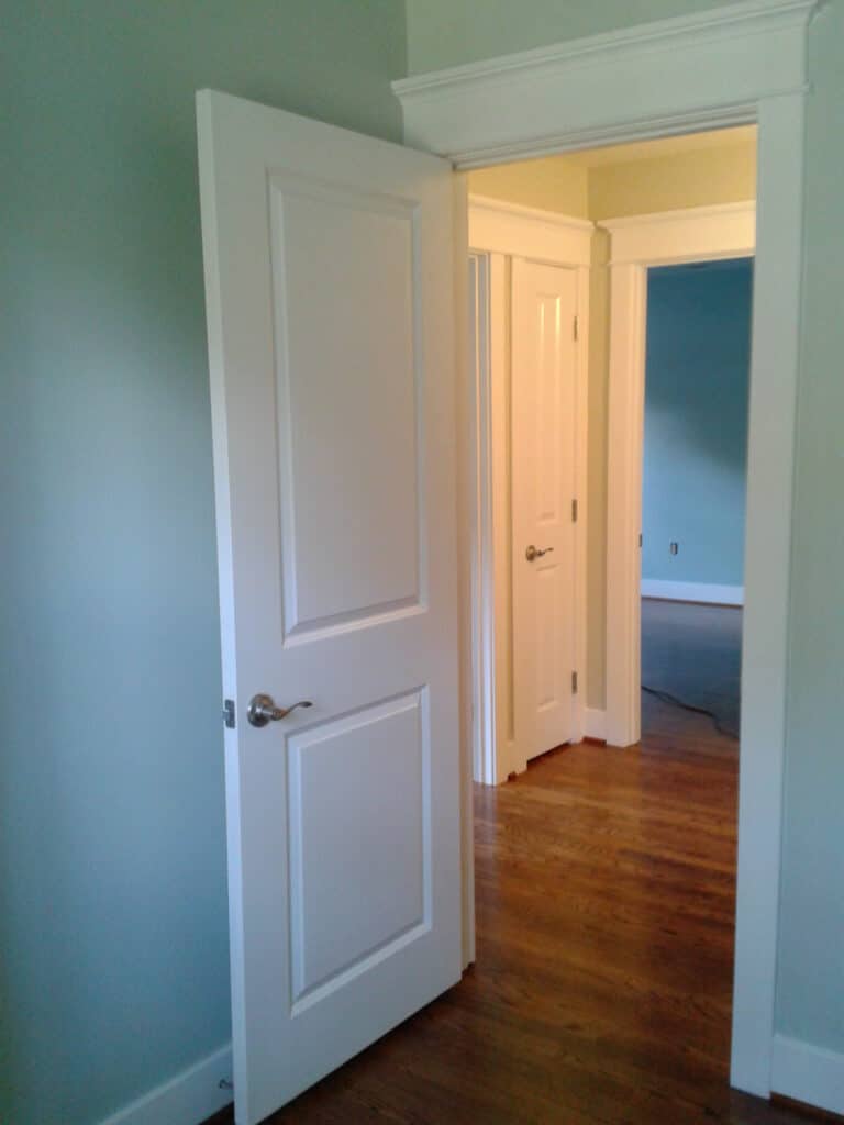 Interior painting in Howard County bedroom with white door and trim