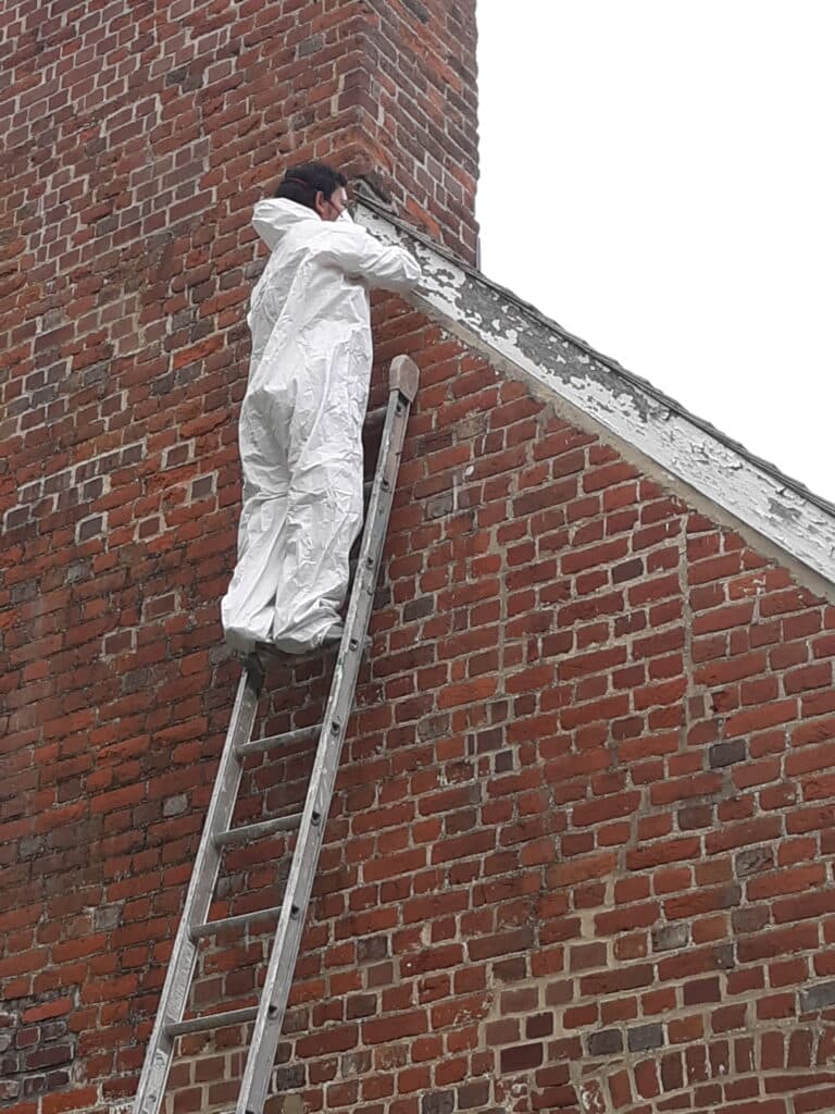 exterior painting in Annapolis includes Sunrise historic property being scraped and painted by klappenberger & Son