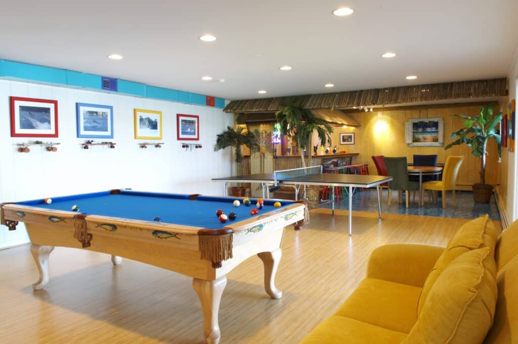 Interior painting in Howard County shows fun room with bright colors, pool table and bar by Klappenberger & Son.