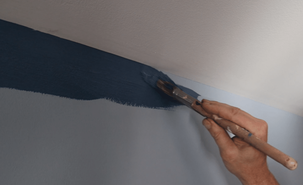 interior painting company in Columbus Ohio painting a wall dark blue.
