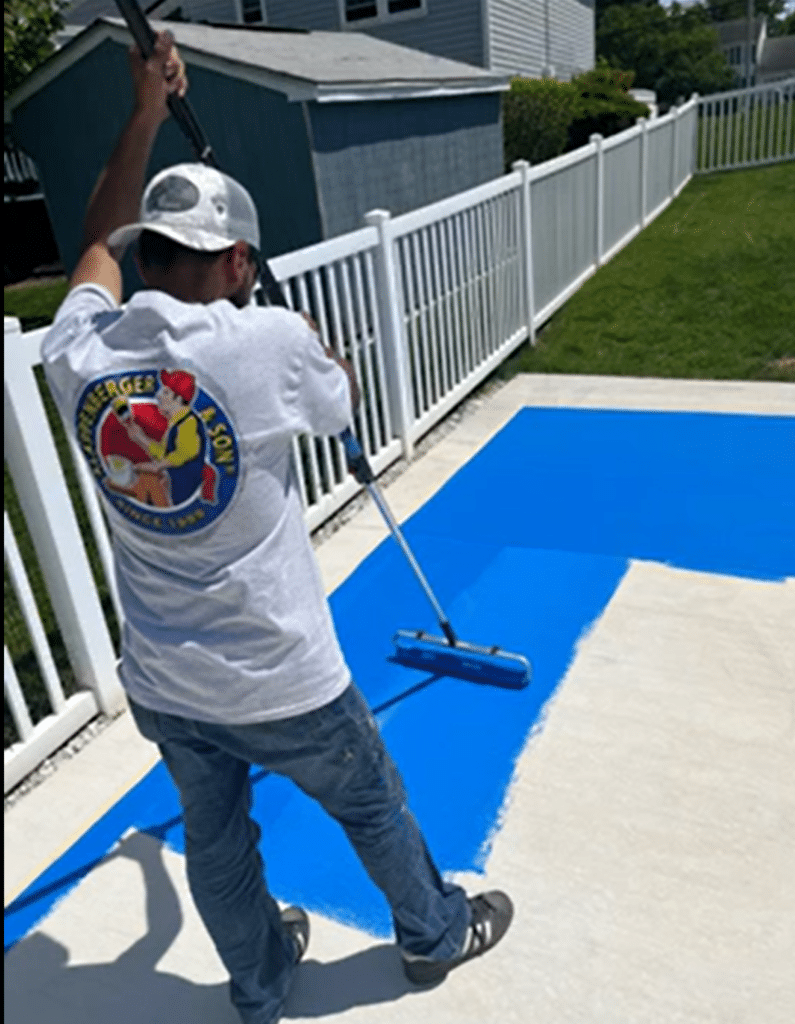 Klappenberger & Son painter paintiingf a pickle ball court.