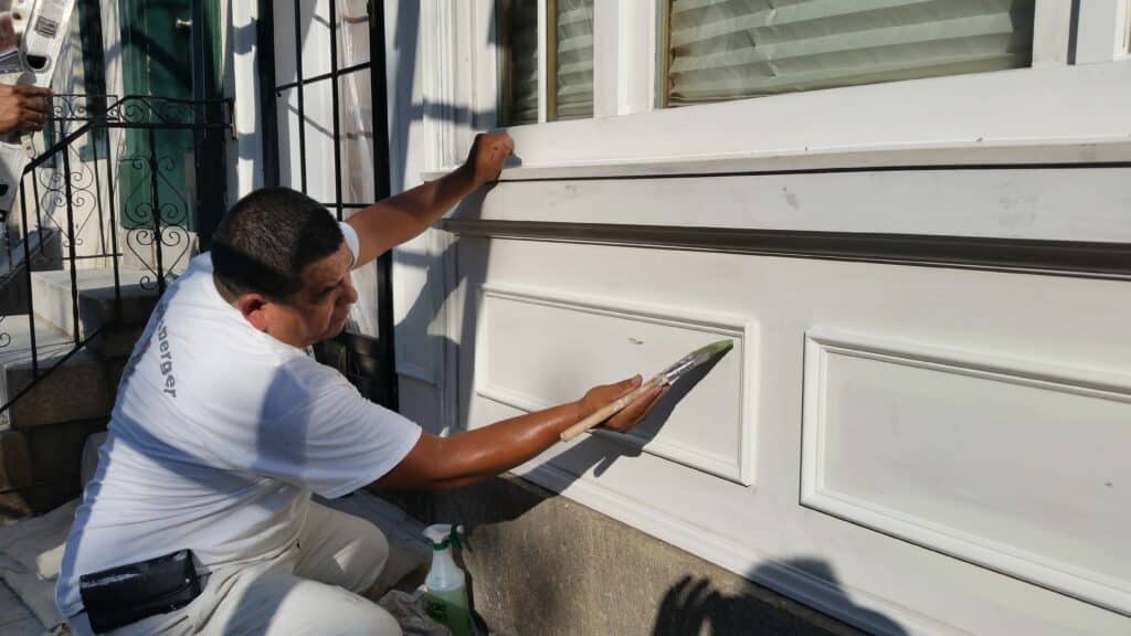 Painter for a day in Baltimore painting a row house.