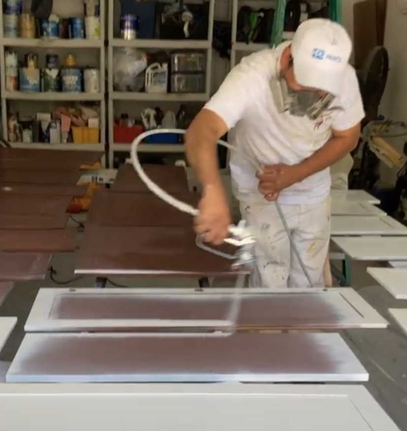 Professional painter painting kitchen cabinets by Klappenberger & Son