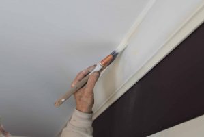 painter painting crown molding