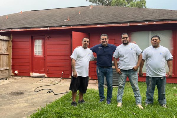 Painting franchisee Luis Camacho with his workers