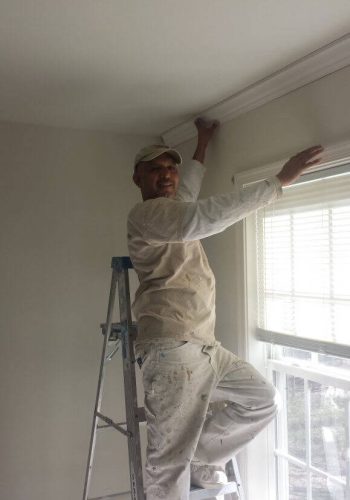 Painters in Anne Arundel County shown here installing crown molding