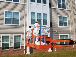 Commercial Painters In Columbus on lift working painting building