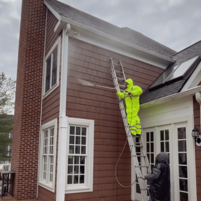 exterior painters in Richmond power washing a house.