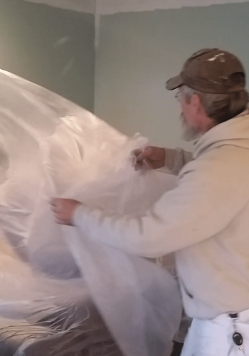interior paINTING IN cOLUMBUS STARTS WITH PROECTING FURNITURE. Klappenberger & Son is covering furniture with plastic.